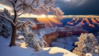 the sun shines over the grand canyon in the winter